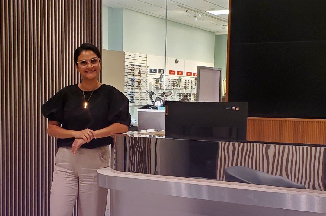 Dr. Fallon Patel at the front desk of a Fallon Vision Group clinic